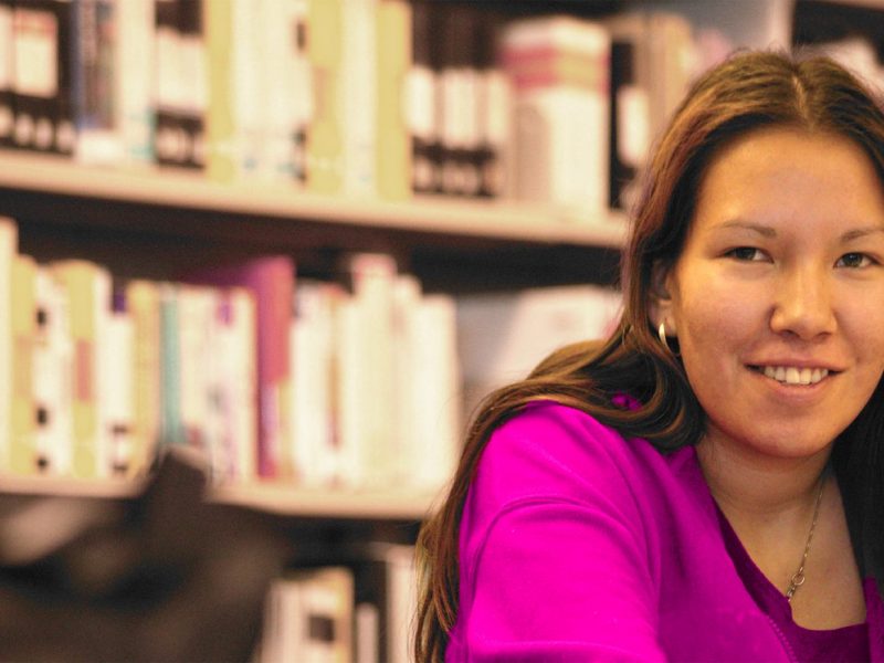 A young indigenous woman in a library.
